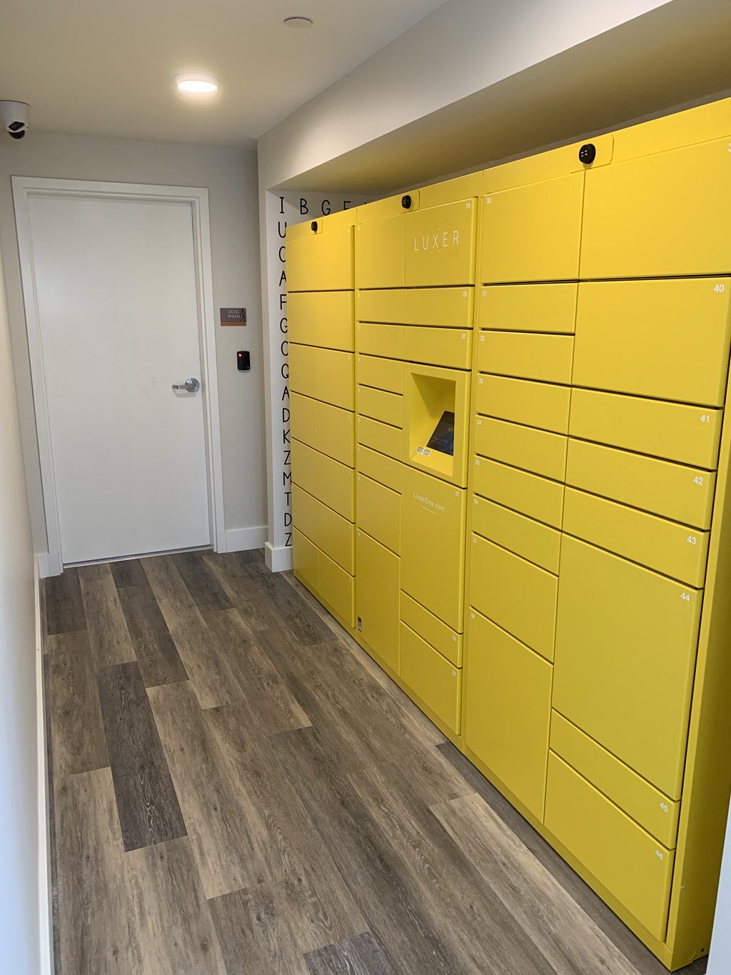 Locker Room with Large Yellow Lockers, Wood Inspired Floor and Locked Door