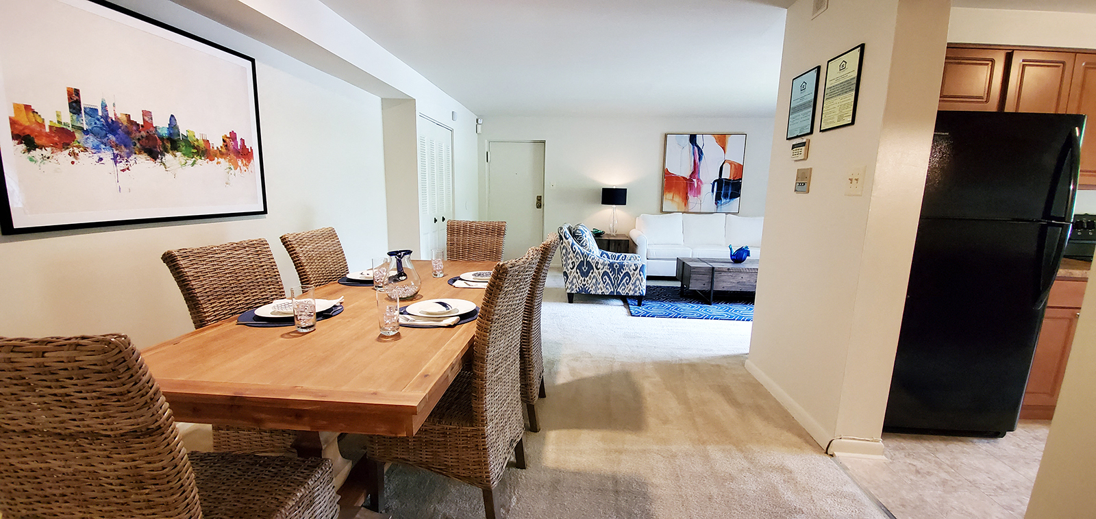A dining room with a wooden table and chairs.