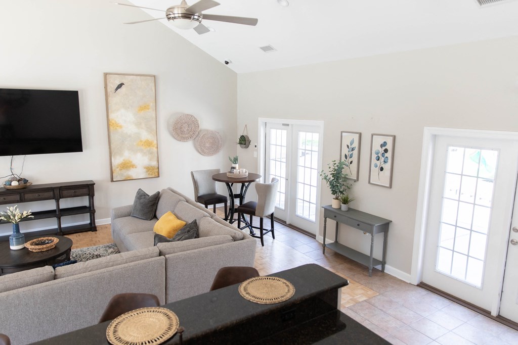 a living room with a gray couch and a tv