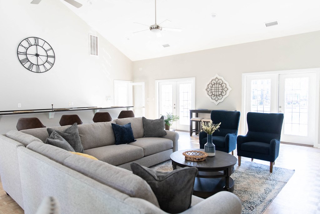 a living room with couches and chairs and a table