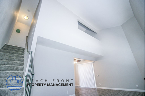 a view of a stairwell from the top of a staircase with a white wall
