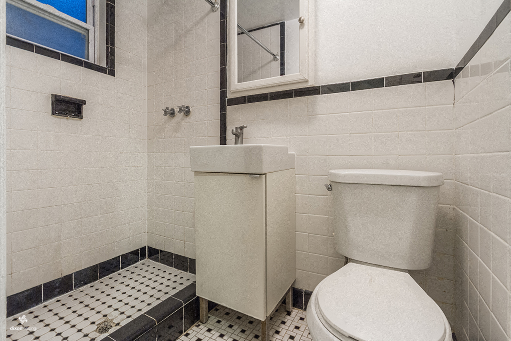 a bathroom with a toilet and a window