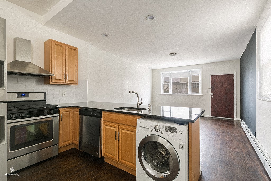a kitchen with a washing machine and a washer in it