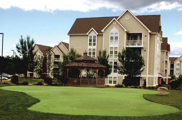 a large yard with a gazebo in front of a house