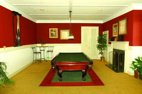 a red living room with a pool table