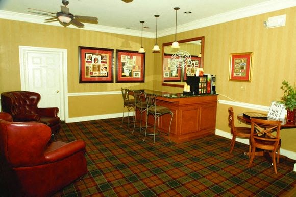 a living room with a dining room table and chairs