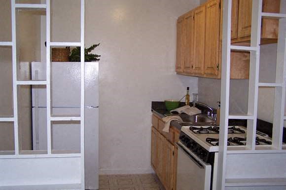 a kitchen with a stove and a refrigerator