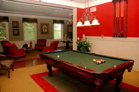 a pool table in the living room of a house