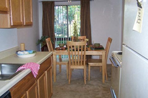 a kitchen with a dining table and chairs
