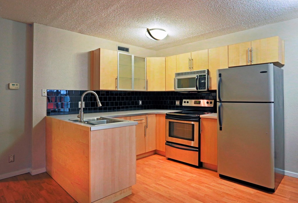 kitchen with brown cabinets and silver appliances