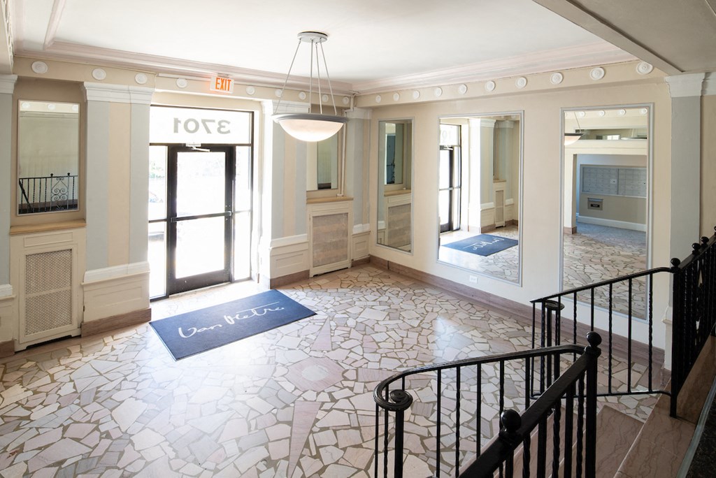 the lobby of a building with a staircase and a sign that says love