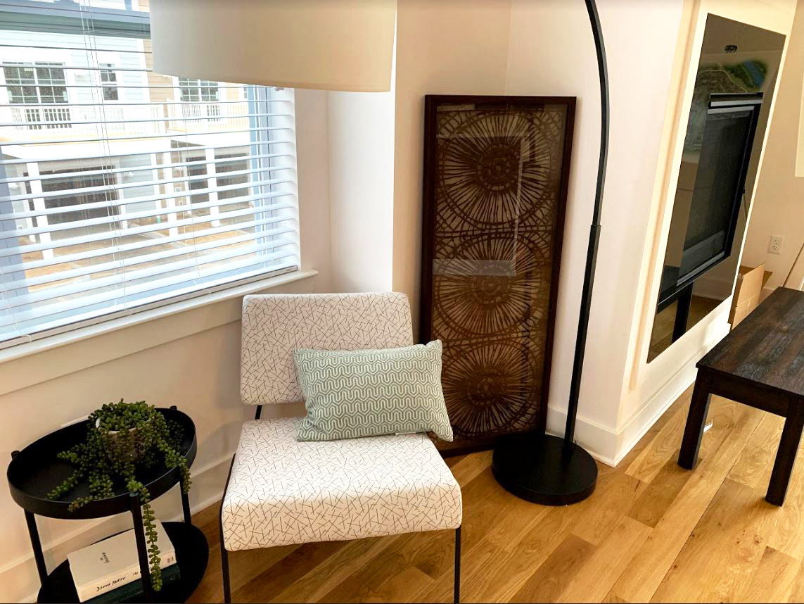 a small living room with a chair and a table