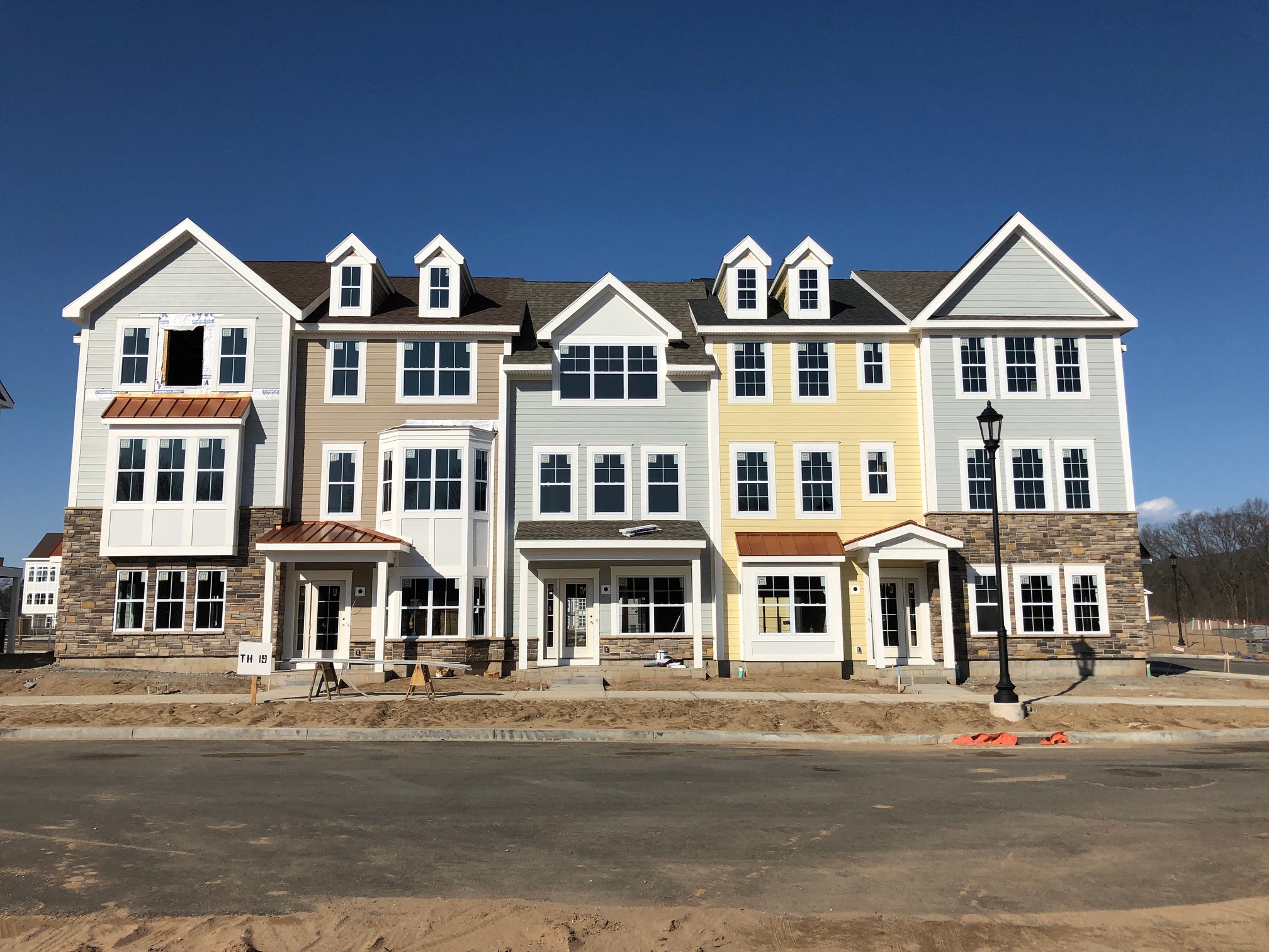 a row of new houses under construction on a street