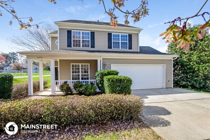 a house with a driveway and a white garage door