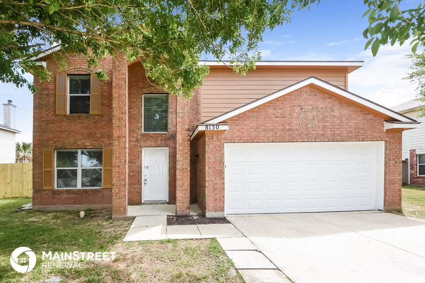 a brick house with a white garage door