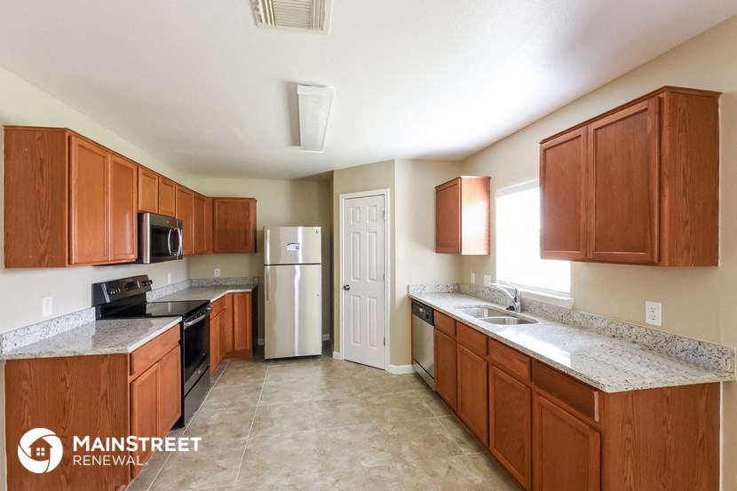 a kitchen with wooden cabinets and stainless steel appliances