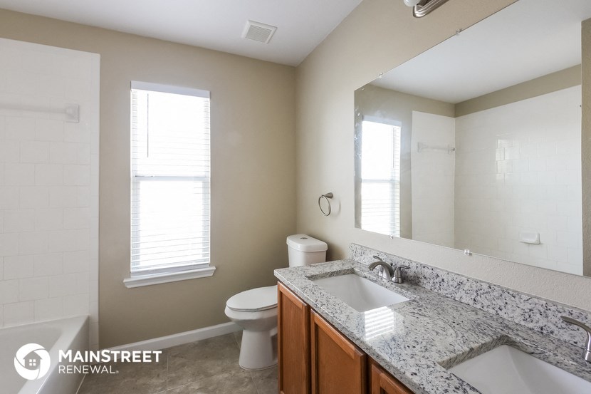 a bathroom with a sink and a toilet and a mirror