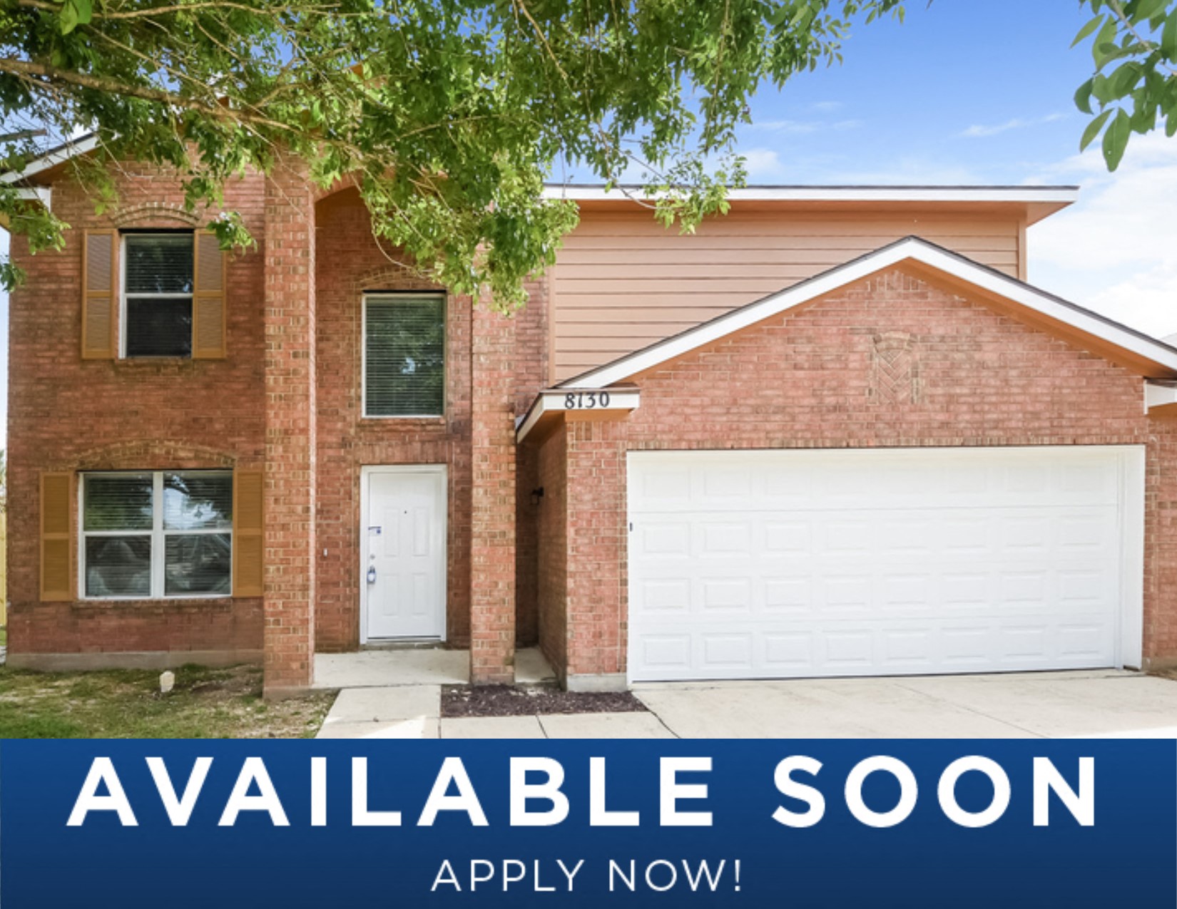 a updated brick home with a white garage door