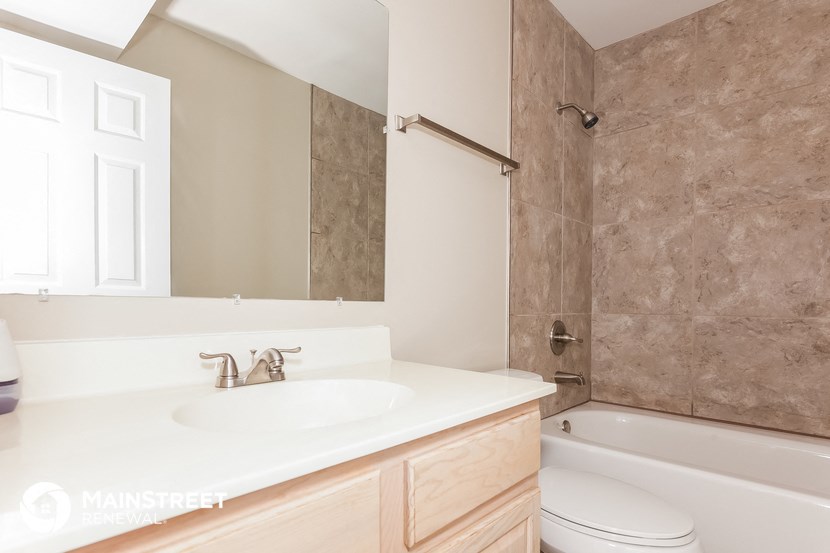 a bathroom with a sink and a shower and a toilet