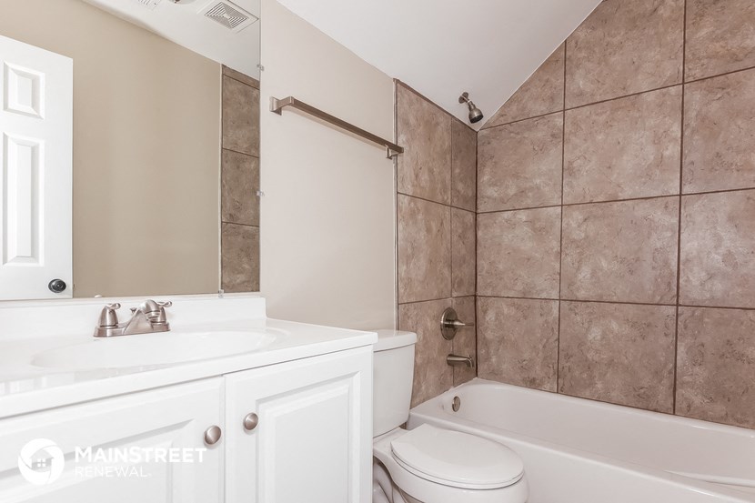 a bathroom with a sink toilet and shower and a tub