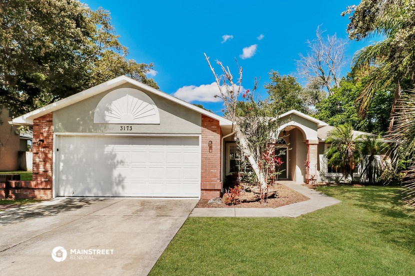 a house with a white garage door and a lawn