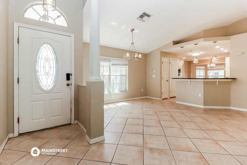 an open kitchen and living room with a white door