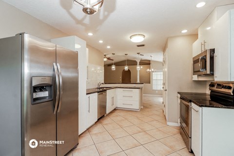 a kitchen with stainless steel appliances and white cabinets