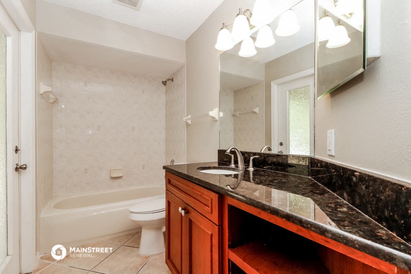 a bathroom with a sink and a toilet and a mirror