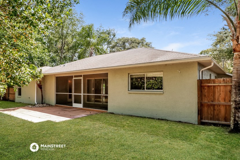 a white house with a yard and a wooden fence