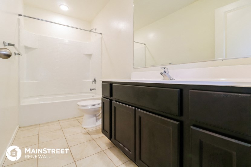 a bathroom with a sink and a toilet and a bath tub