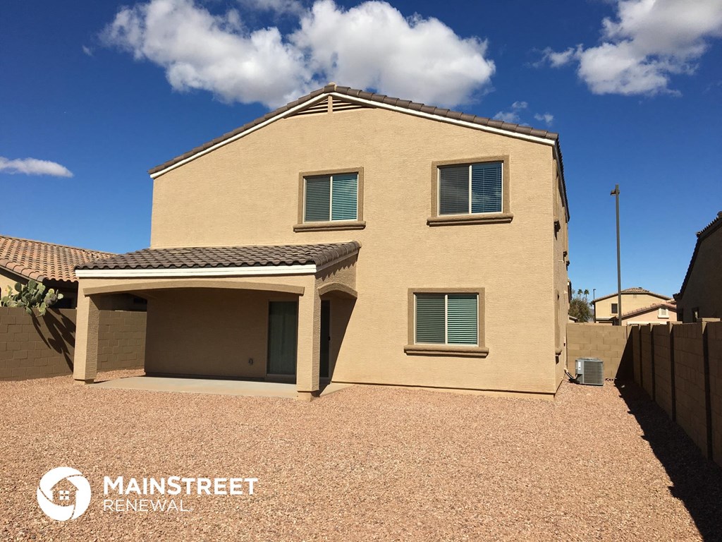 a house with a gravel driveway and a roof