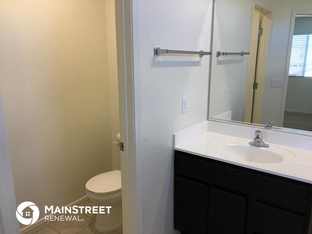 a bathroom with a sink and a toilet and a mirror