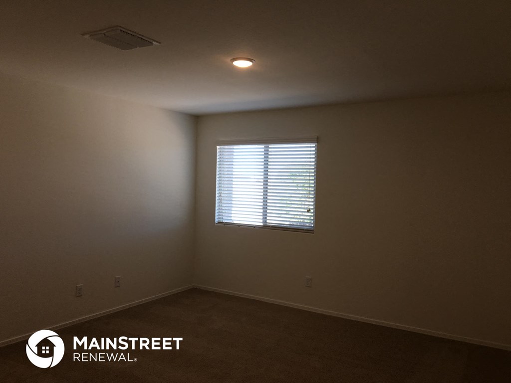 the interior of an empty room with a window