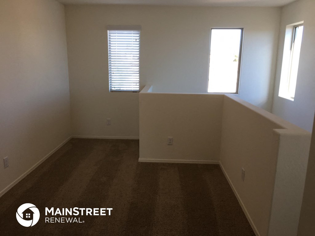 an empty room with white walls and a window