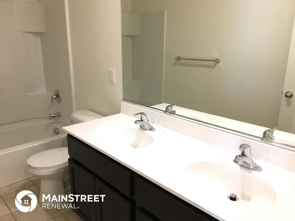 a bathroom with a white sink and a mirror