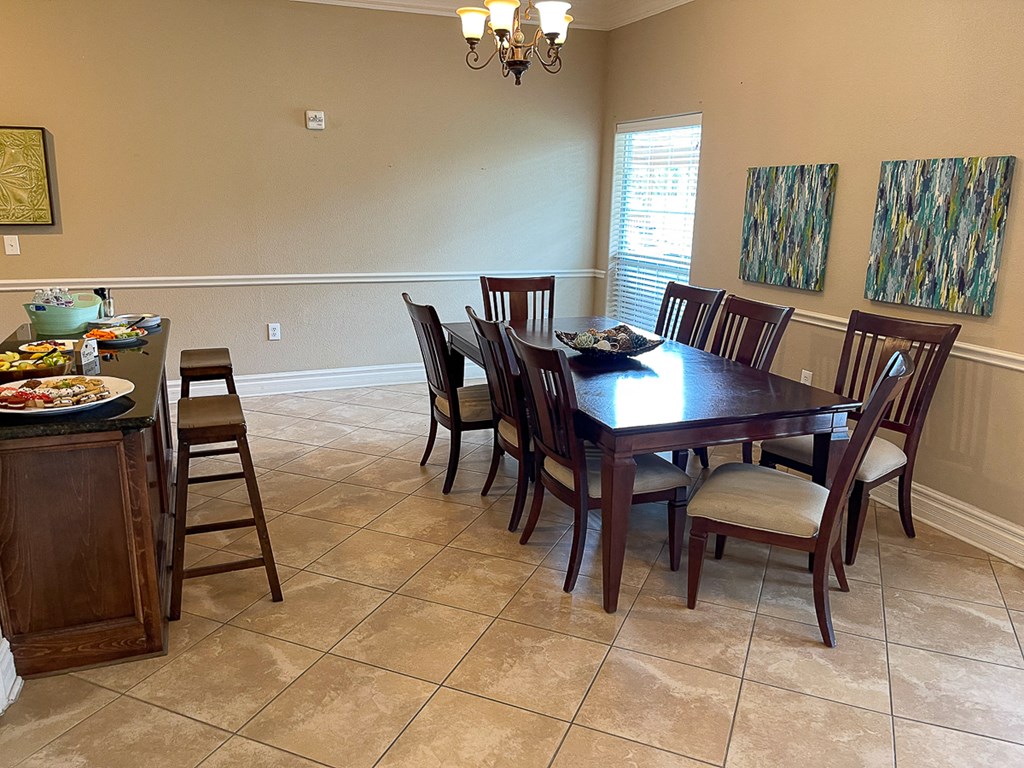 a dining room with a wooden table and chairs