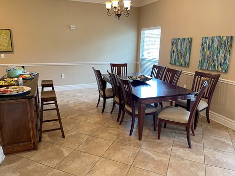 a dining room with a wooden table and chairs