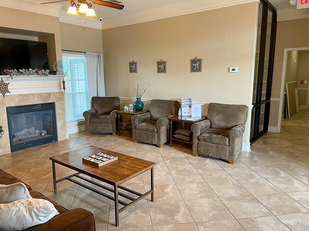 a living room with a fireplace and a coffee table