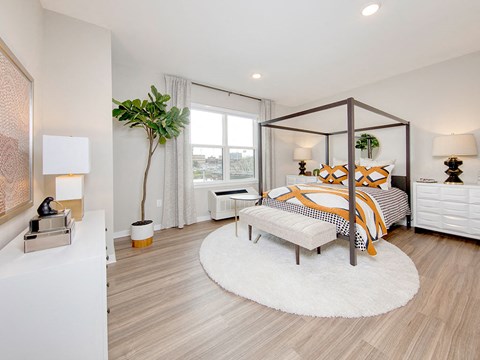 a bedroom with a bed and a window