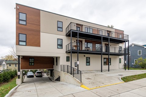 A modern two-story apartment building with a garage.
