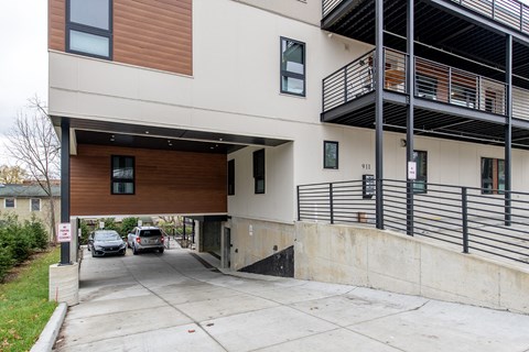 A modern building with a garage and a balcony.