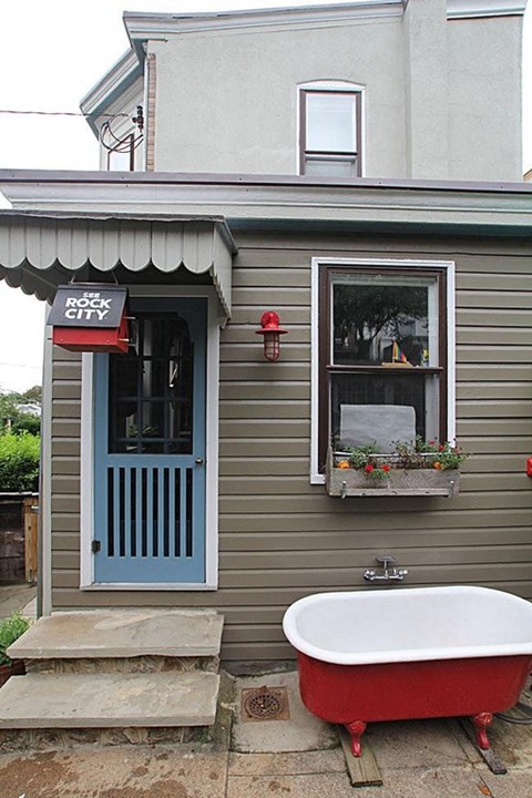A building with a red bathtub outside.