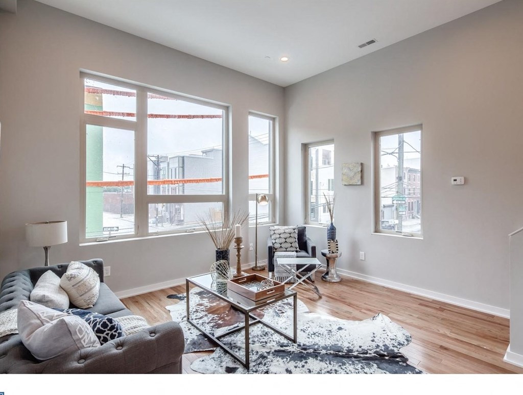 a living room with a couch and a glass coffee table