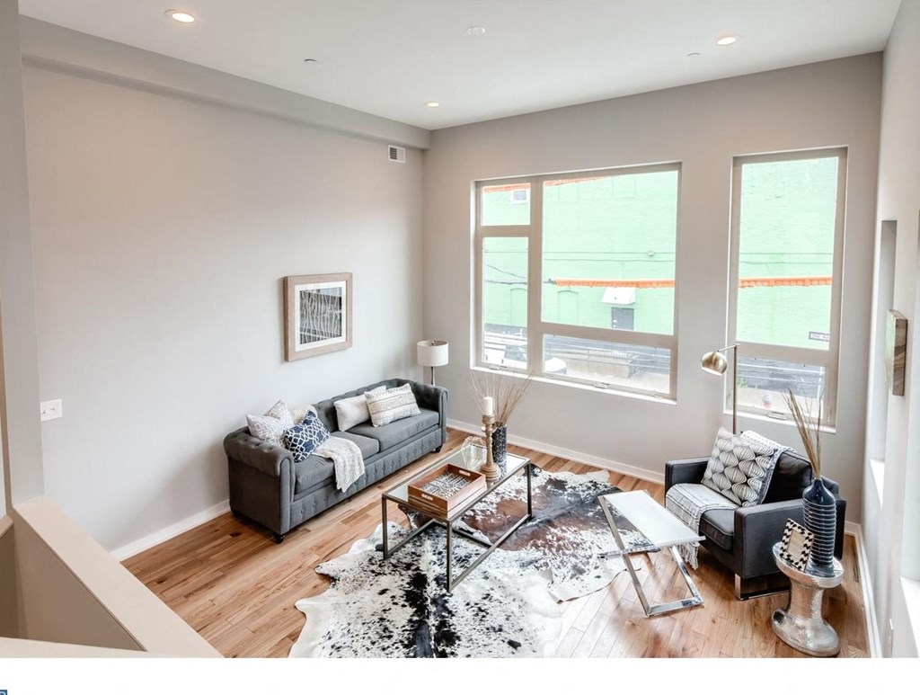 a living room with two couches and a glass coffee table