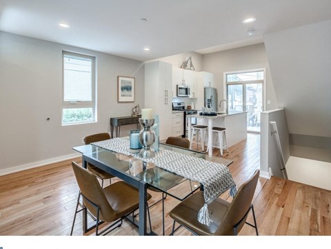 an open kitchen and dining room with a table and chairs