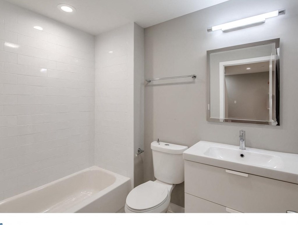 a bathroom with a sink toilet and a mirror