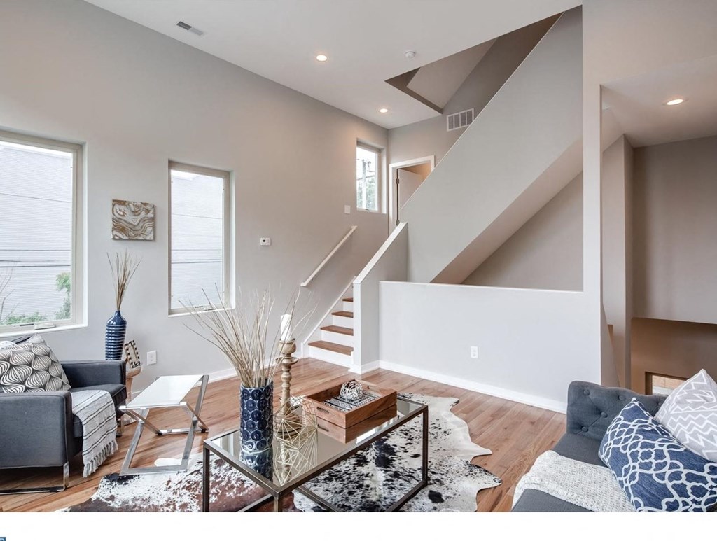 a living room with a couch and a glass coffee table