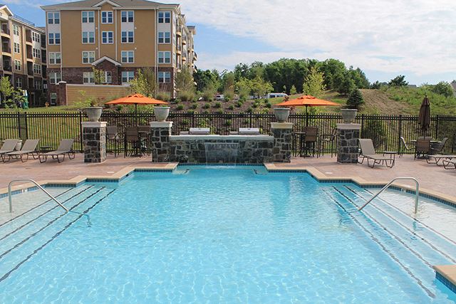 a swimming pool with chairs and umbrellas at the resort