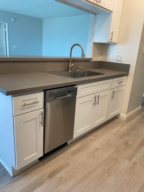 a kitchen with white cabinets and a sink