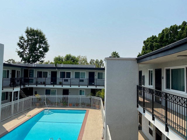 a large swimming pool in front of a building